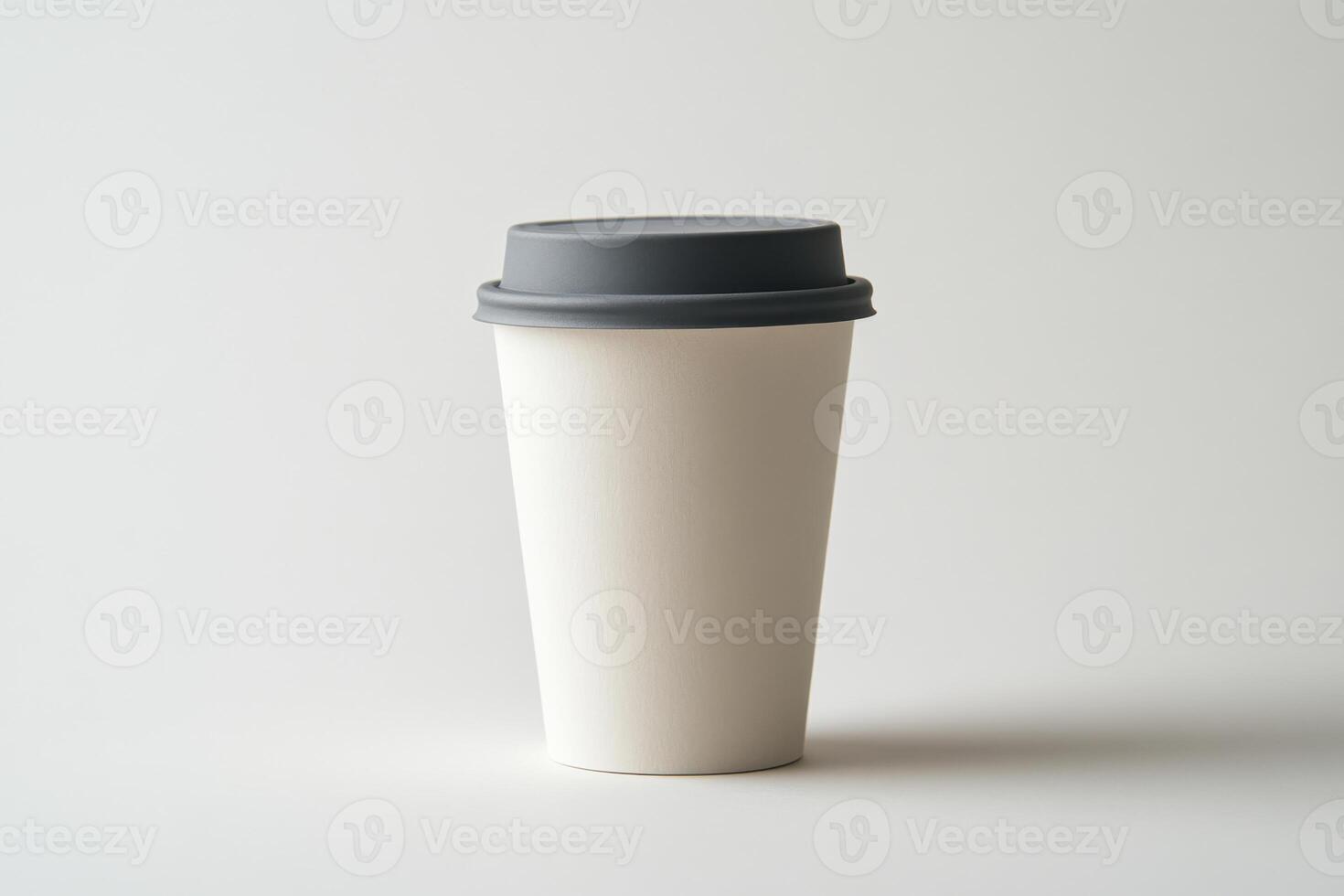 White paper coffee cup with gray lid isolated on white background with sharp detail and minimalistic aesthetic photo