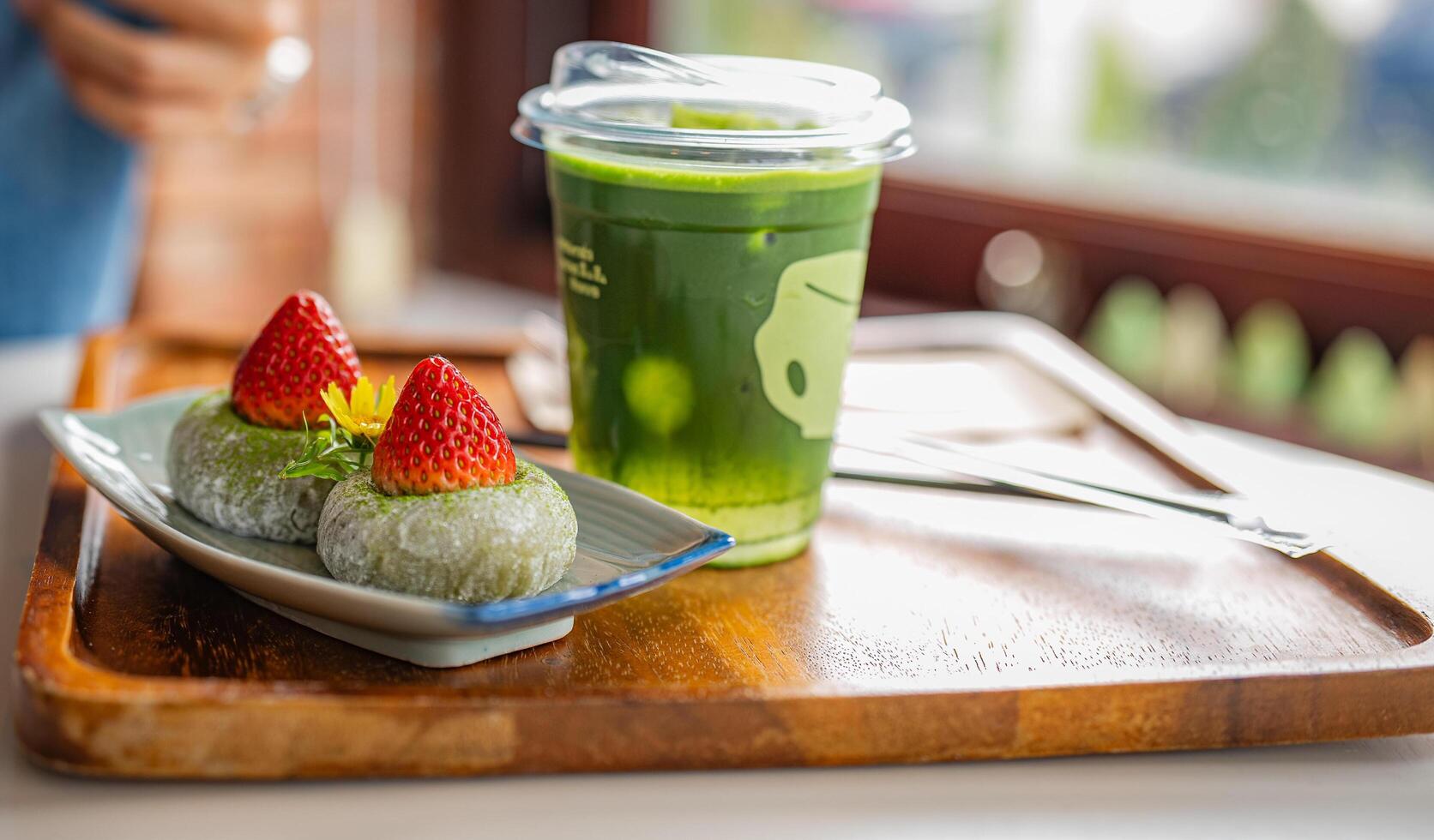 green tea moji daifuku sweets in plate with ice cofee and ice matcha green tea on wooden table at cafe photo