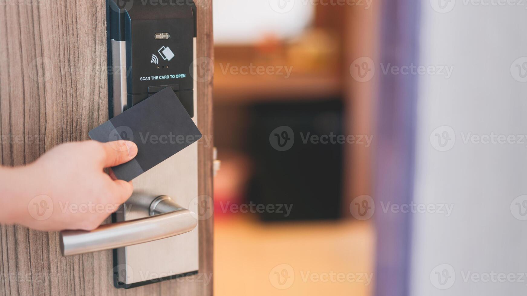 A person holding a credit card to a door handle photo