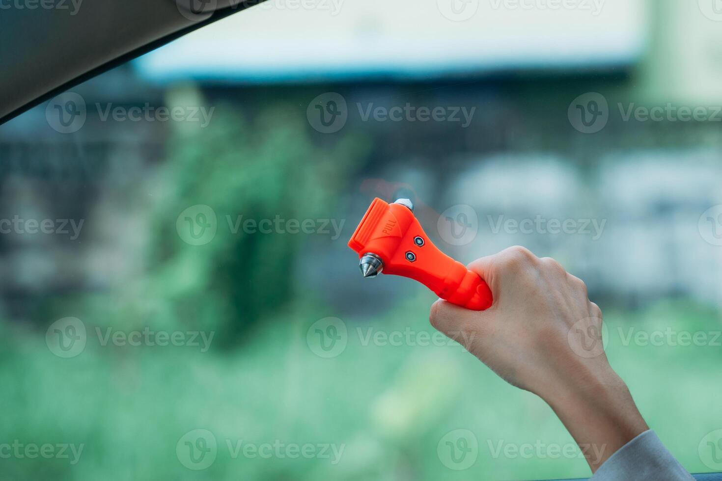 A person holding a red plastic toy in their hand photo