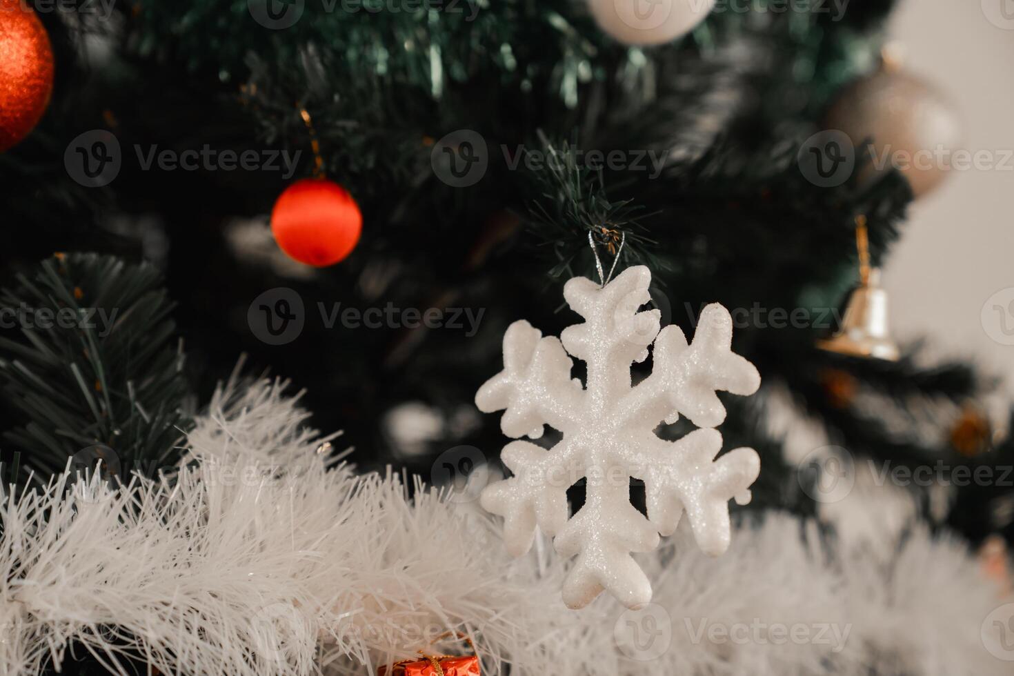 A christmas tree with ornaments and snowflakes photo