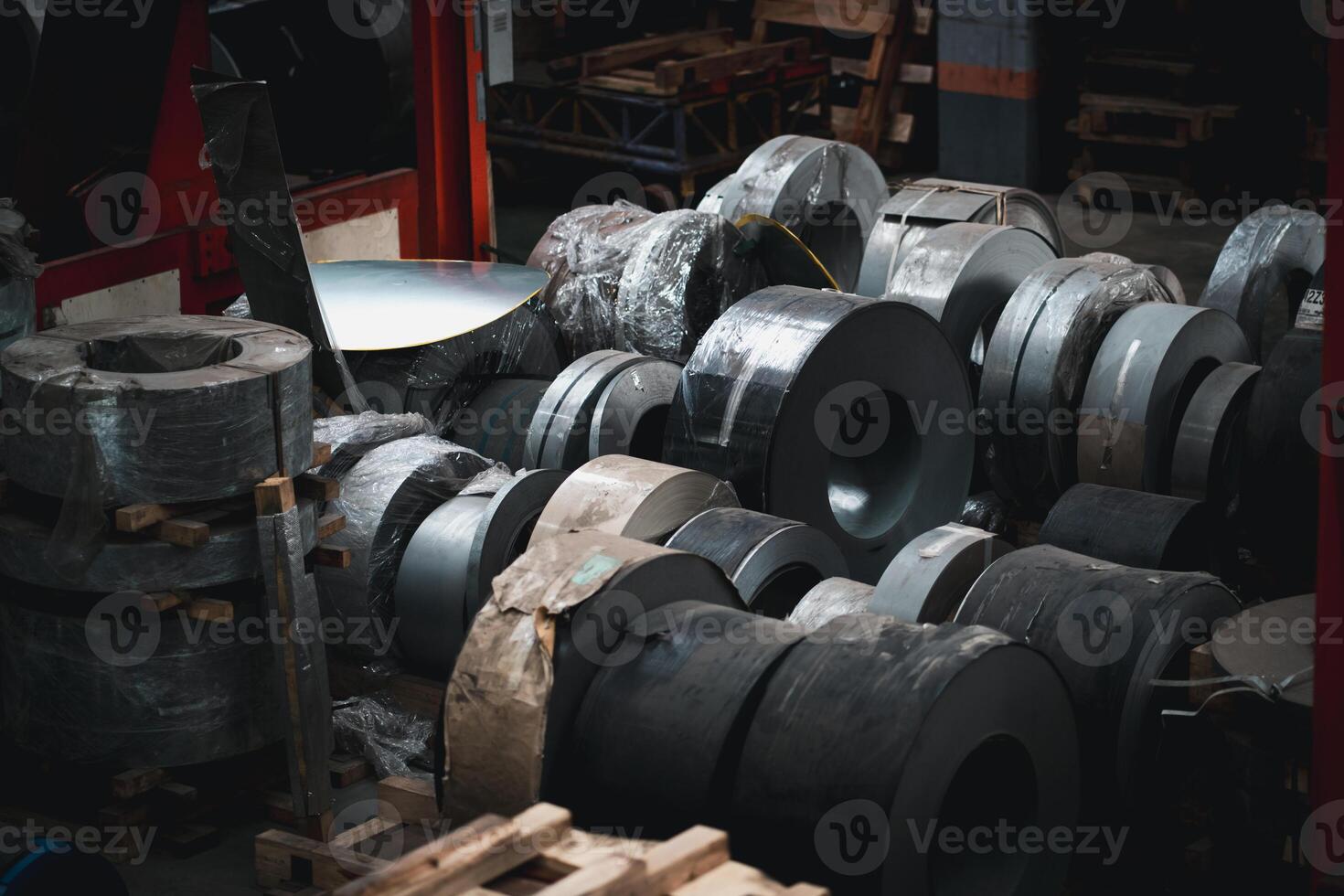 A large pile of steel rolls in a warehouse photo