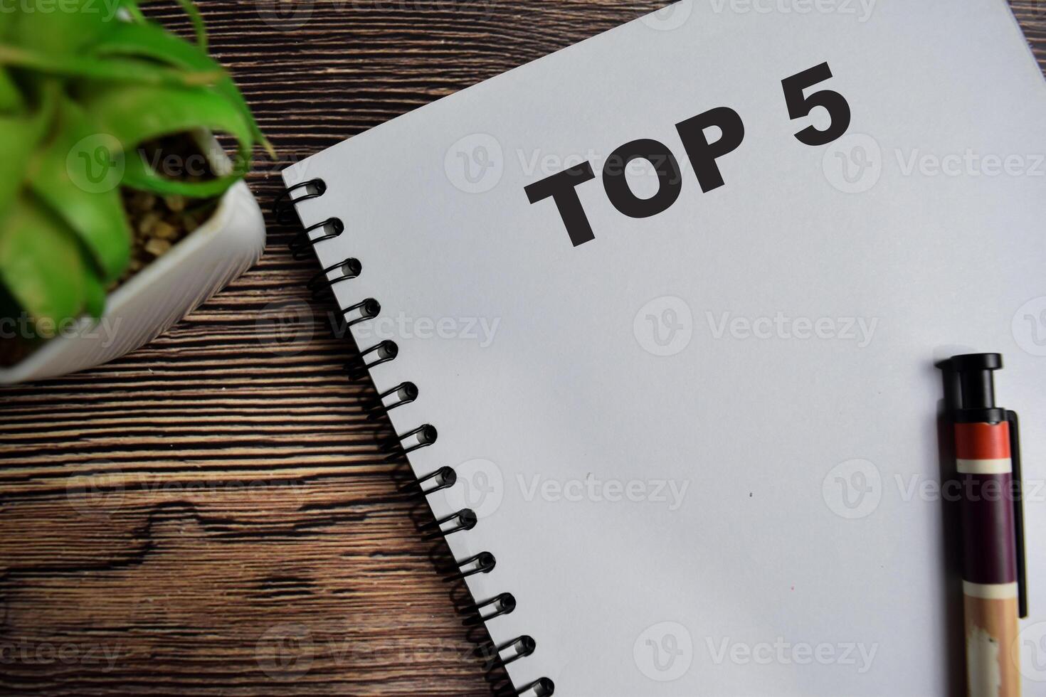 Concept of TOP 5 on book isolated on Wooden Table. photo