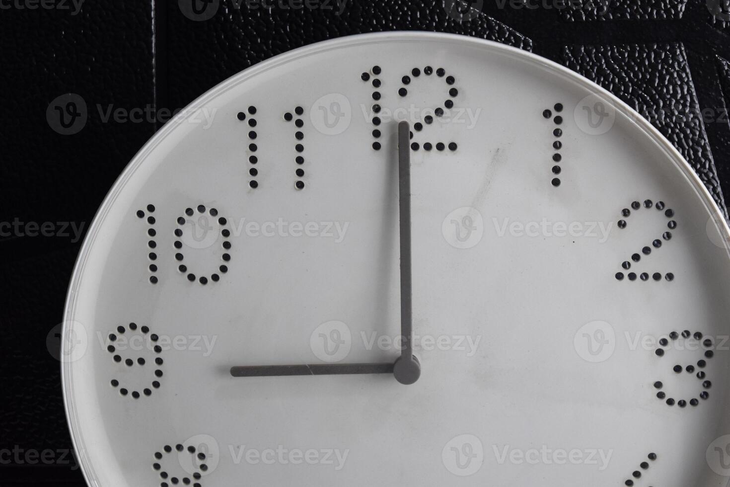 Focus time in clock of nine o'clock for design in your business concept isolated on black background photo