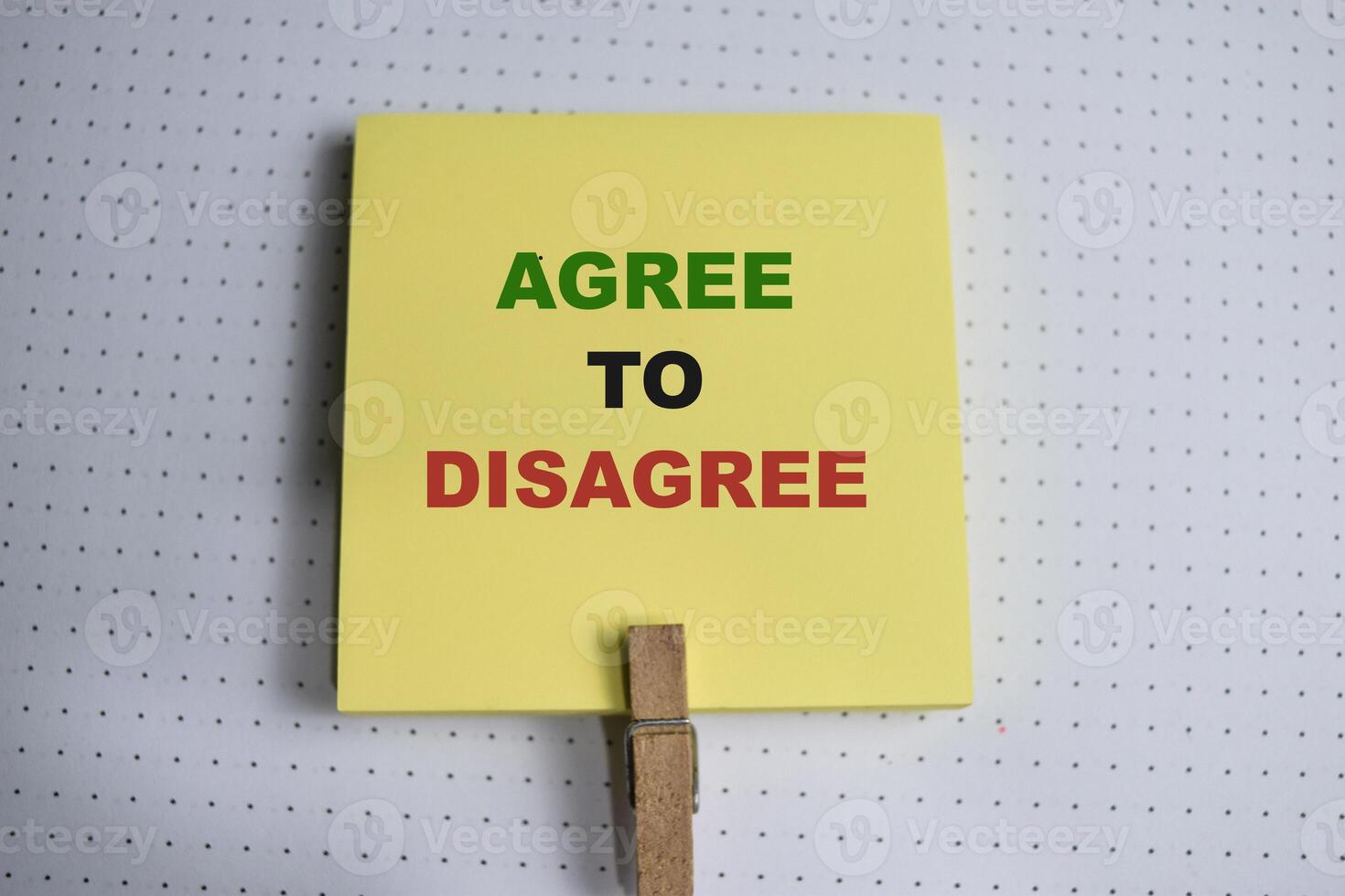 Concept of Agree to Disagree write on sticky notes isolated on Wooden Table. photo