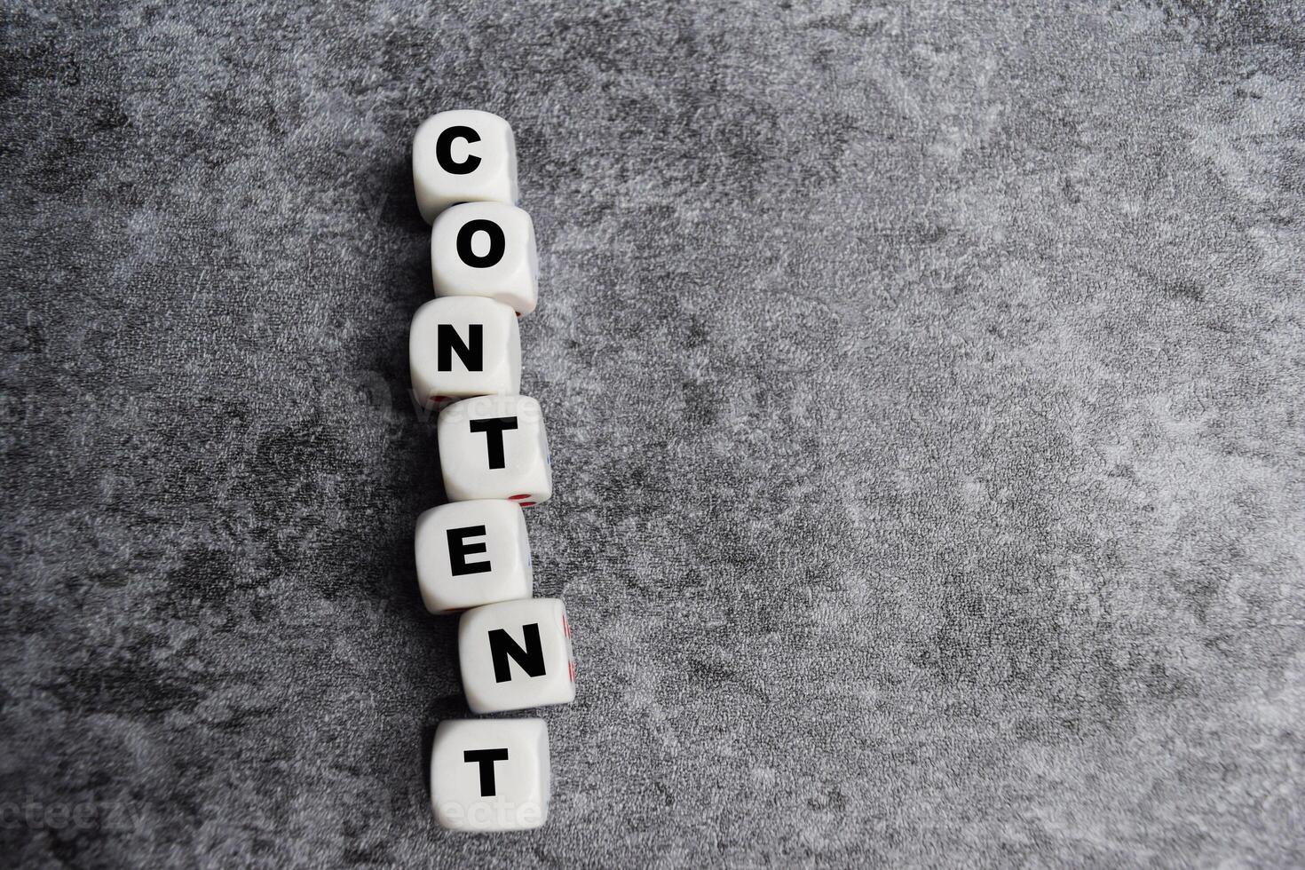 The word content on stacked wooden cubes on the table. content creation or management business information photo