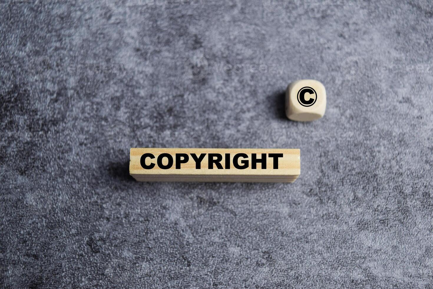 The word copyright and copyright symbol on wooden blocks on the table. concept of patenting or copyright protection photo