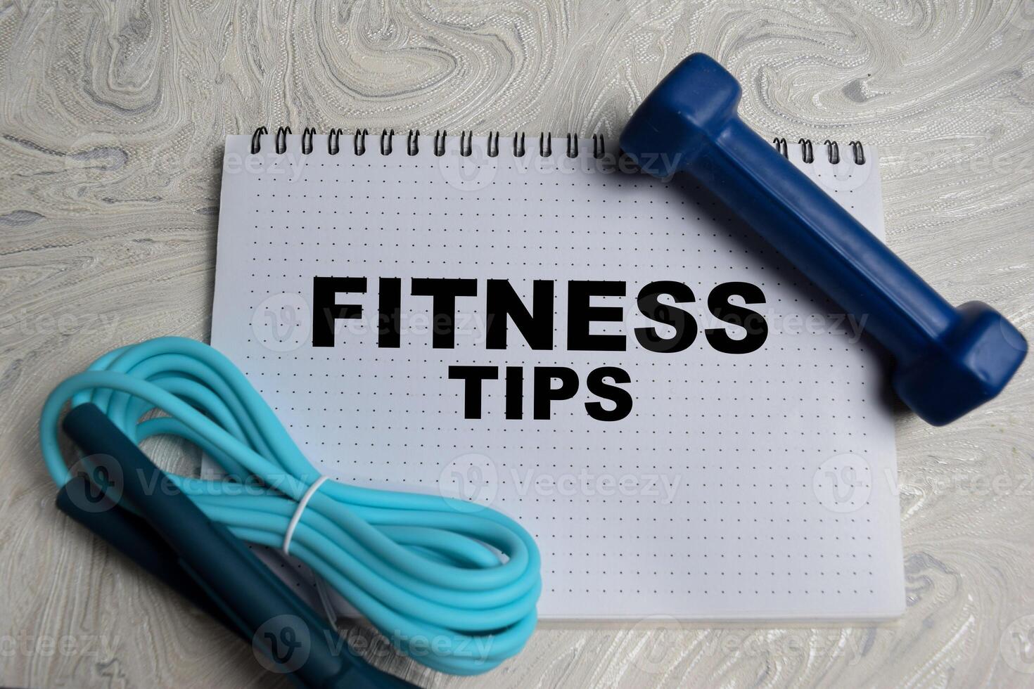 Concept of Fitness Tips write on book isolated on Wooden Table. photo