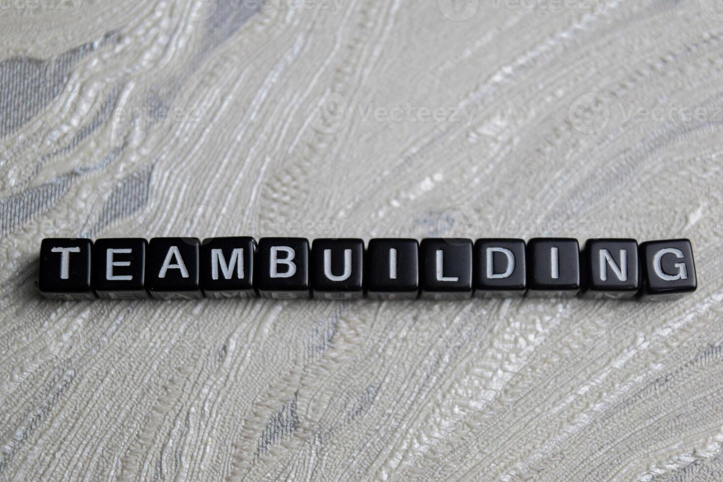 Concept of Team building written on wooden blocks. Cross processed image on Wooden Background photo