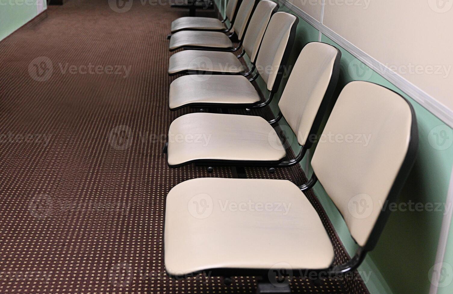Empty hospital waiting room in lobby with reception counter at medical facility, used to help patients with appointments and healthcare insurance. Medical waiting area with front desk. photo