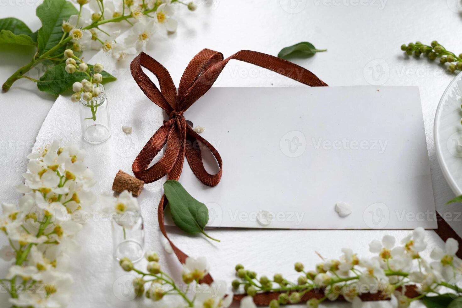 Beautiful tea setup with blank card and fresh flowers, perfect for invitations or notes in a cozy setting photo