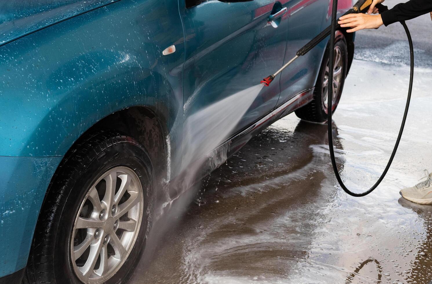 car wash outside. Summer Car Washing. Cleaning Car Using High Pressure Water. Washing with soap. Close up concept. photo