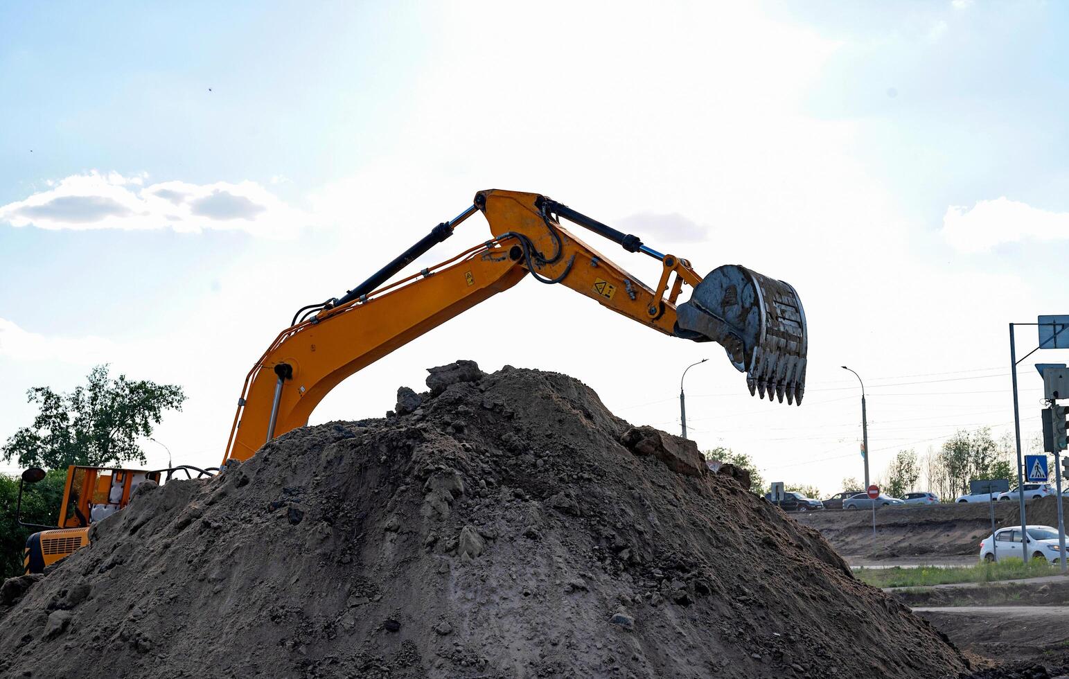 blue sky background. Construction machinery and earth-moving heavy equipment for excavation, loading, lifting and hauling of cargo on job sites photo