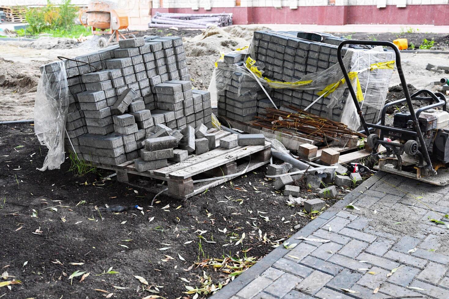 Low angle lleveling sand and cement tiles for precise pavement of the outside patio or sidewalk. Construction industry and renovation. photo