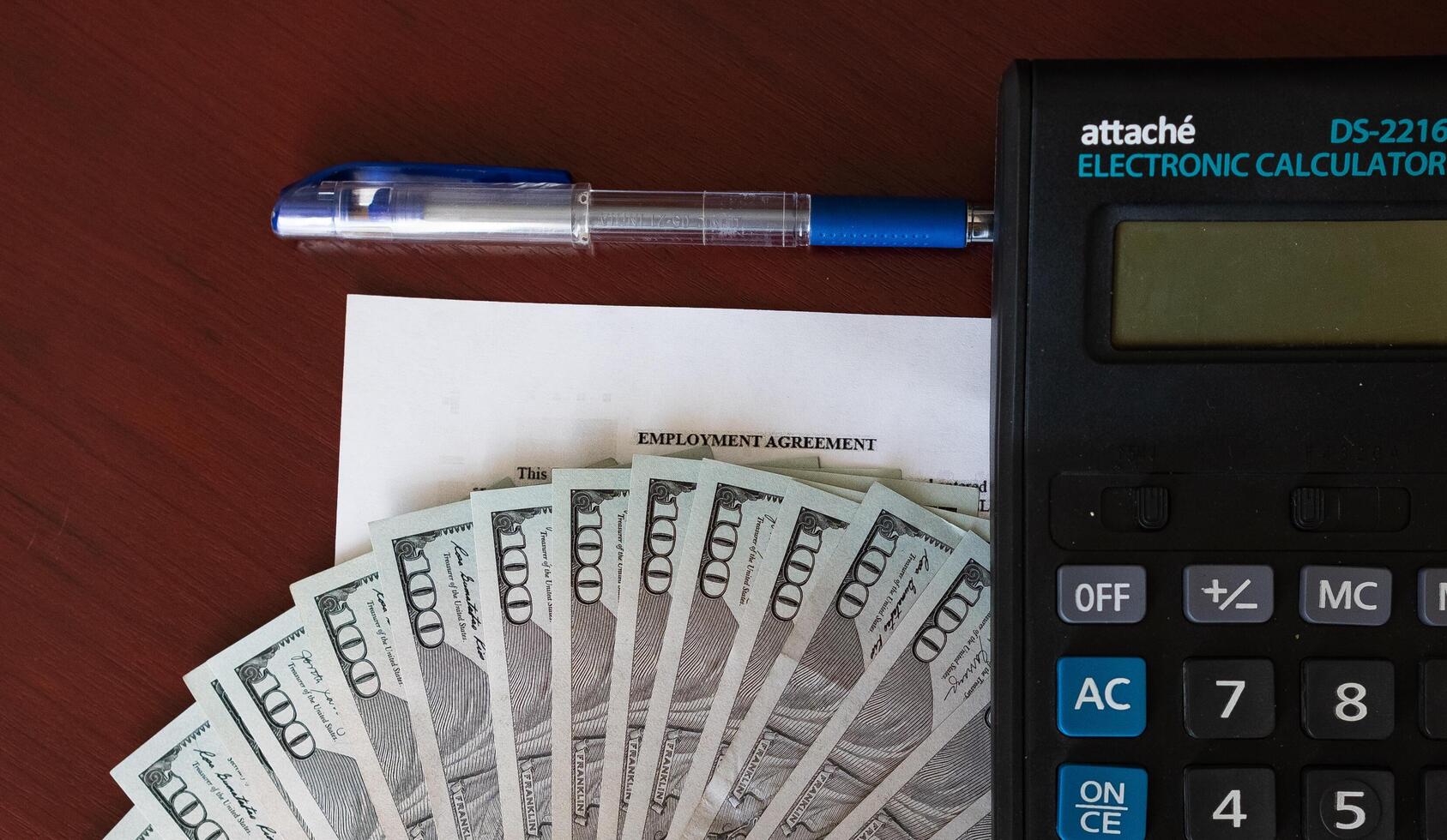 estate agent with customer after contract signature of buying house, Sign contract for more money, US Dollar banknotes money on printed contract paper and pen to sign photo