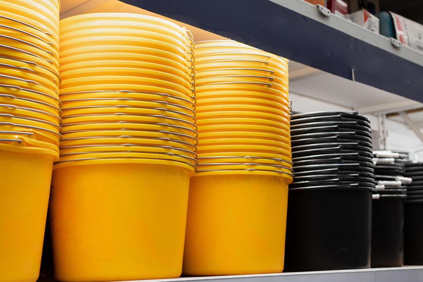 colorful plastic basins and buckets on the counter in a supermarket photo