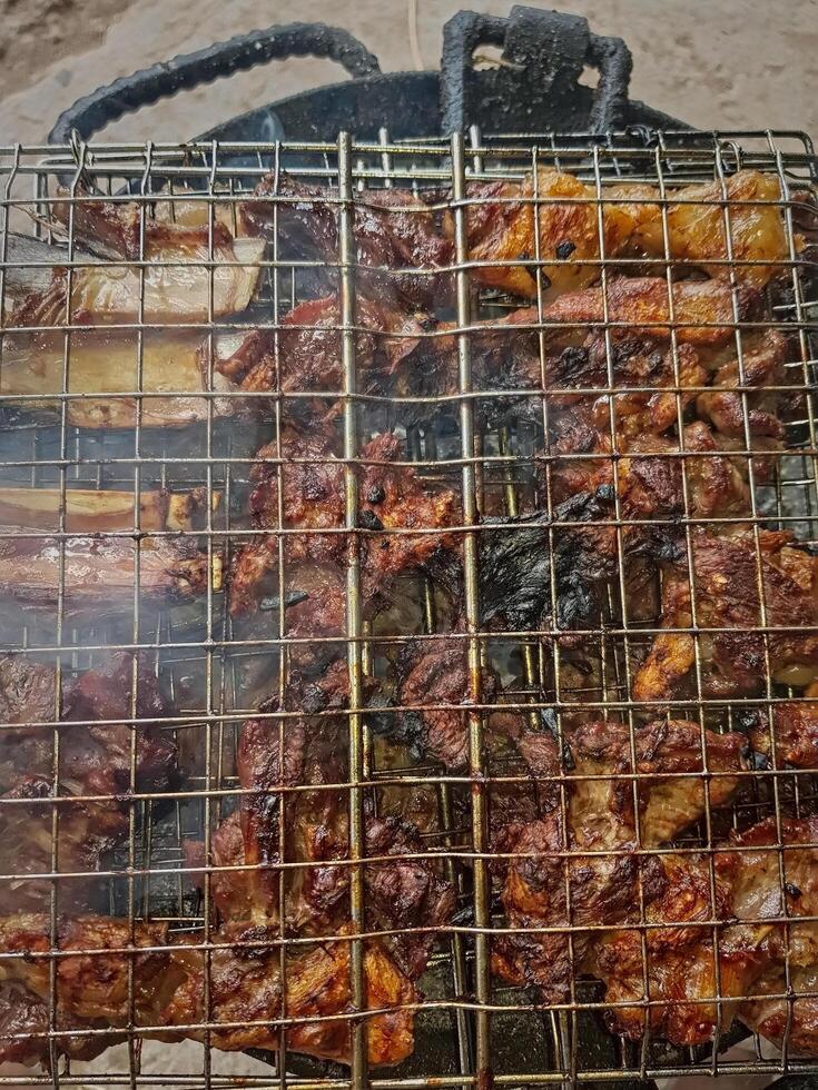 The meat cell grill on the flame in this captivating close scene. When smoke and grease are clarified, rich scents and vibrant colors come in life, and the art of outdoor cooking is exposed photo
