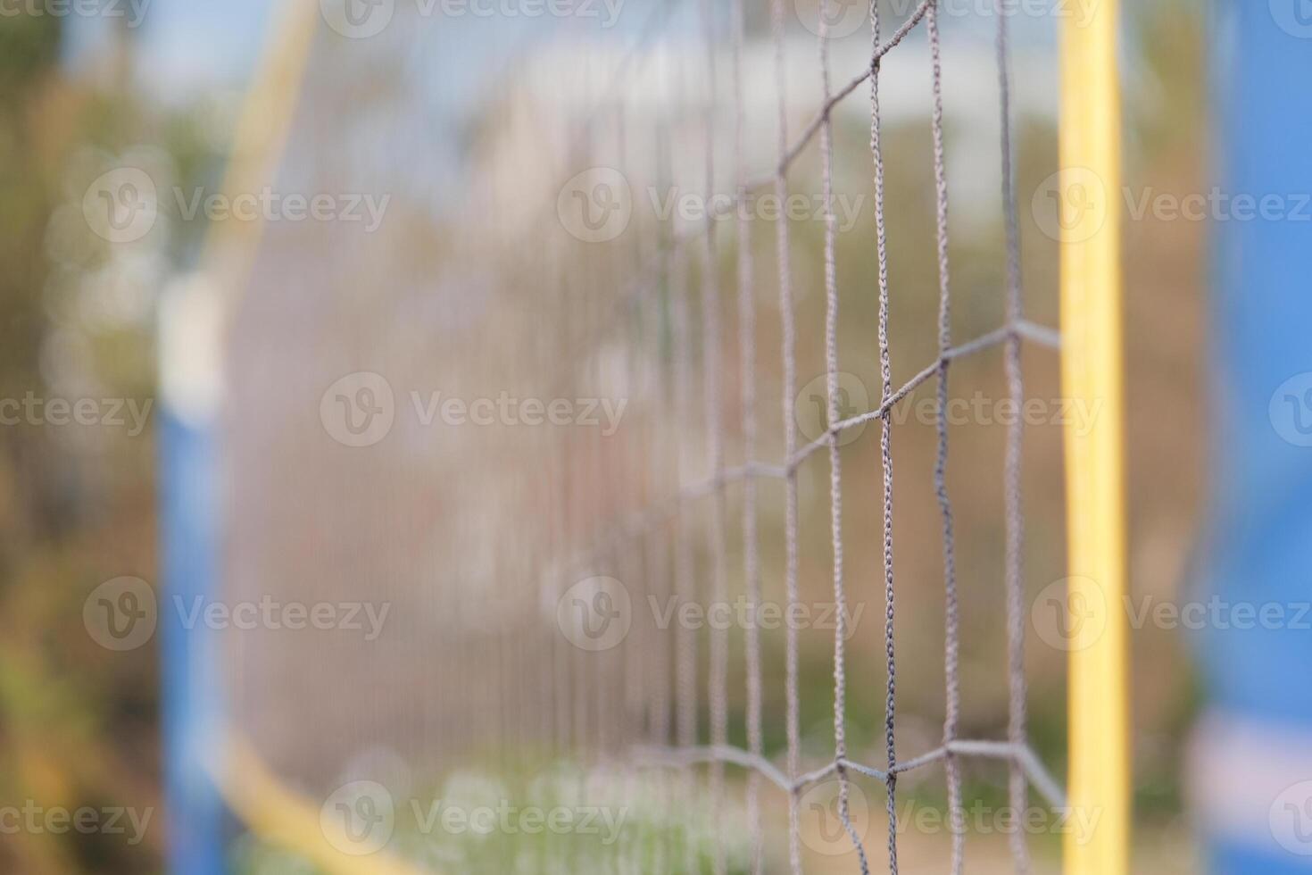 Beach volleyball net on a sunny day, shallow depth of field photo