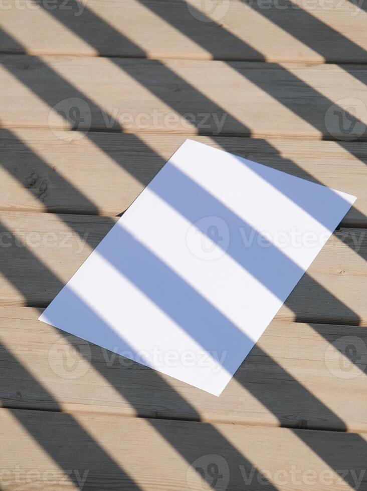 poster paper mockup on rustic wooden background with shadow stripes photo