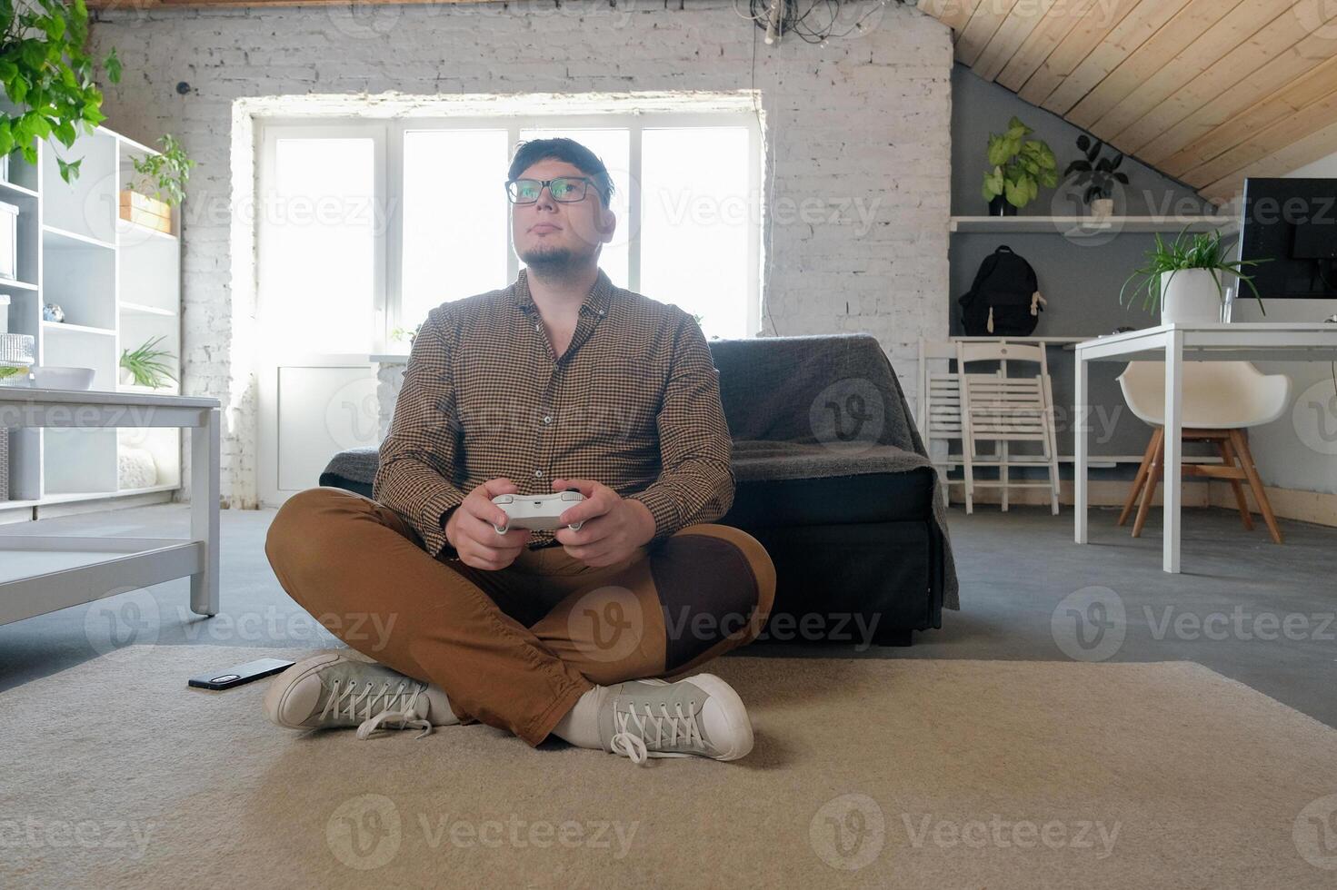 youngCaucasian man playing games using controller photo