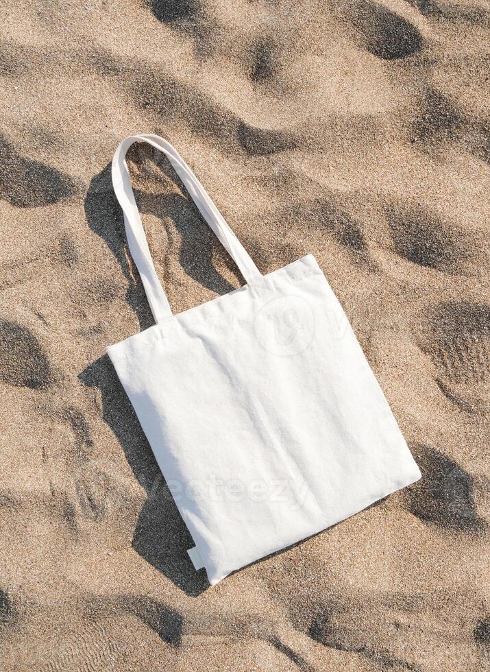 mesh bag on beach sand background photo