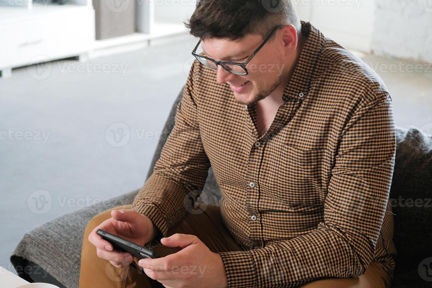 happy Caucasian man have live stream and win mobile game on the smartphone at home photo
