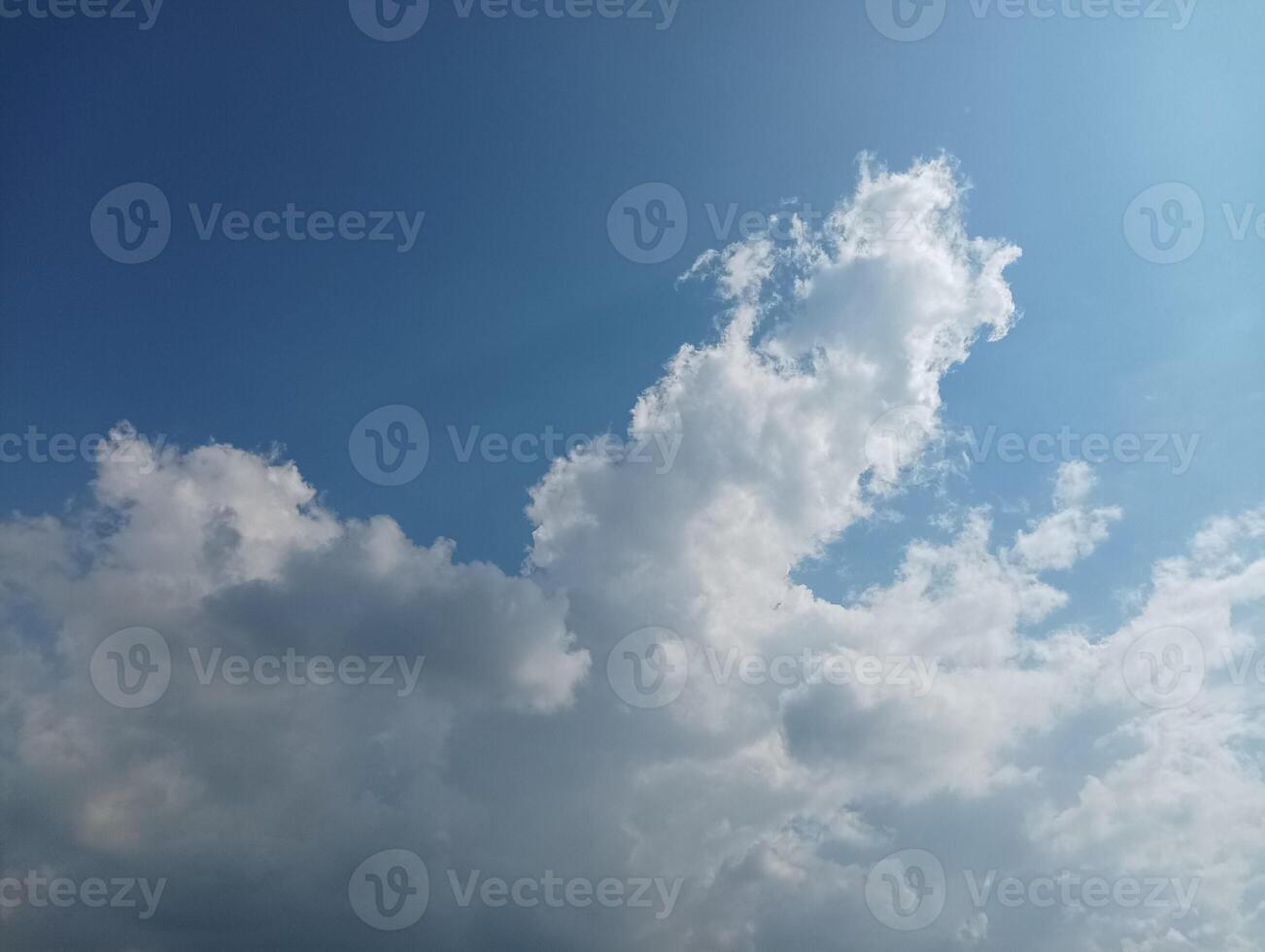 Fluffy white clouds against a vibrant blue sky photo