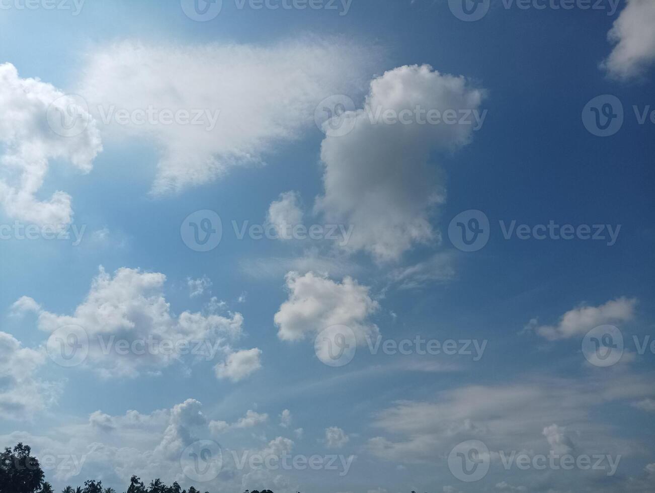 Bright Sky with Fluffy Clouds on a Sunny Day photo