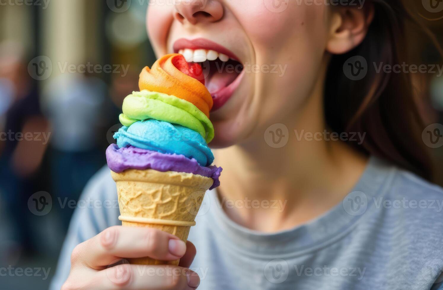 LGBTQ Pride month . Colorful rainbow ice cream cone enjoyed by young person on a sunny day photo