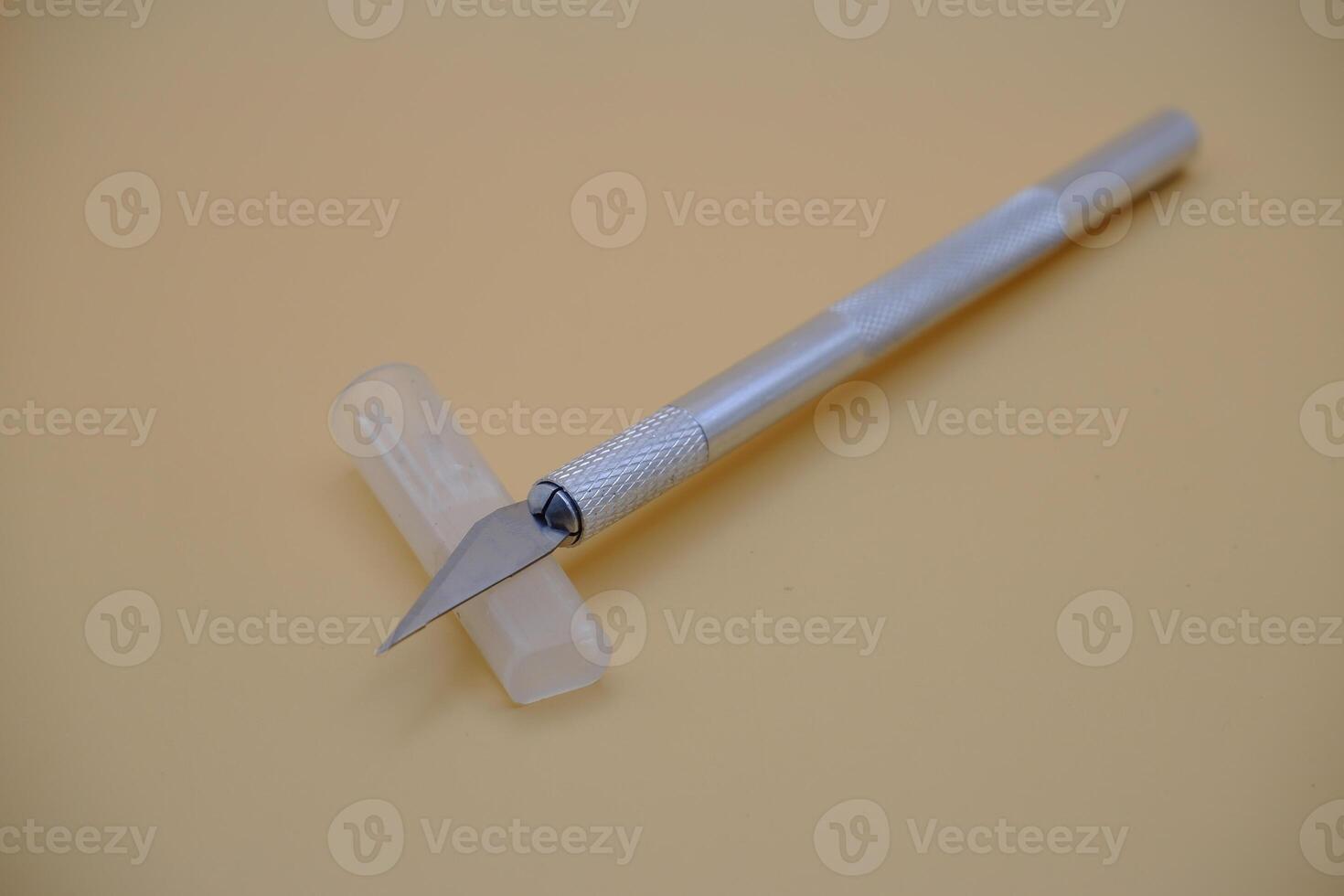 Precision Craft Knife with Safety Cap on Neutral Background photo