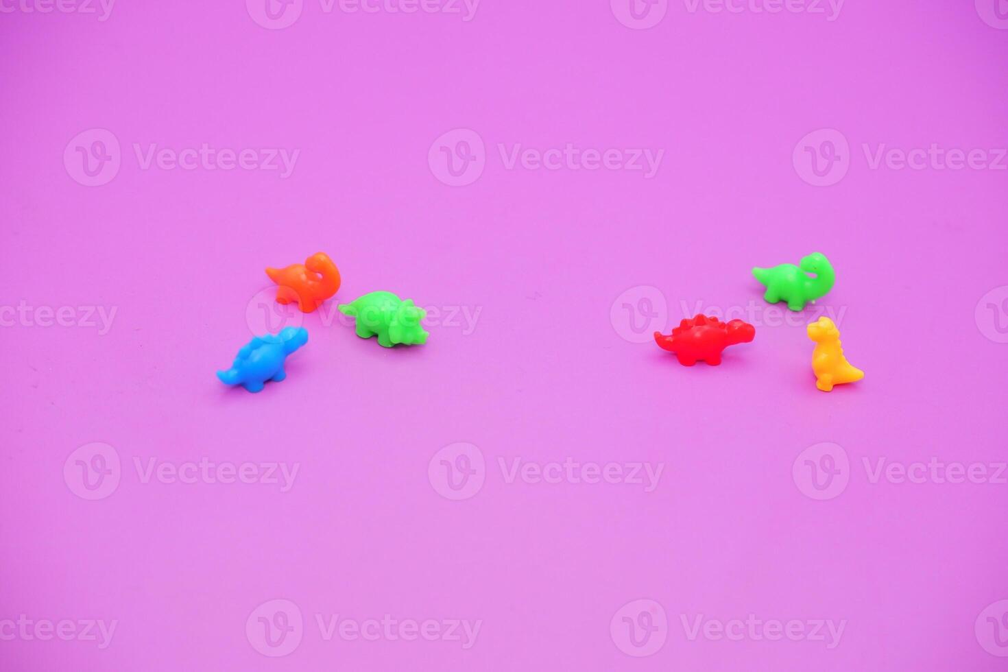 Assorted Tiny Dino Toys in Rainbow Colors photo