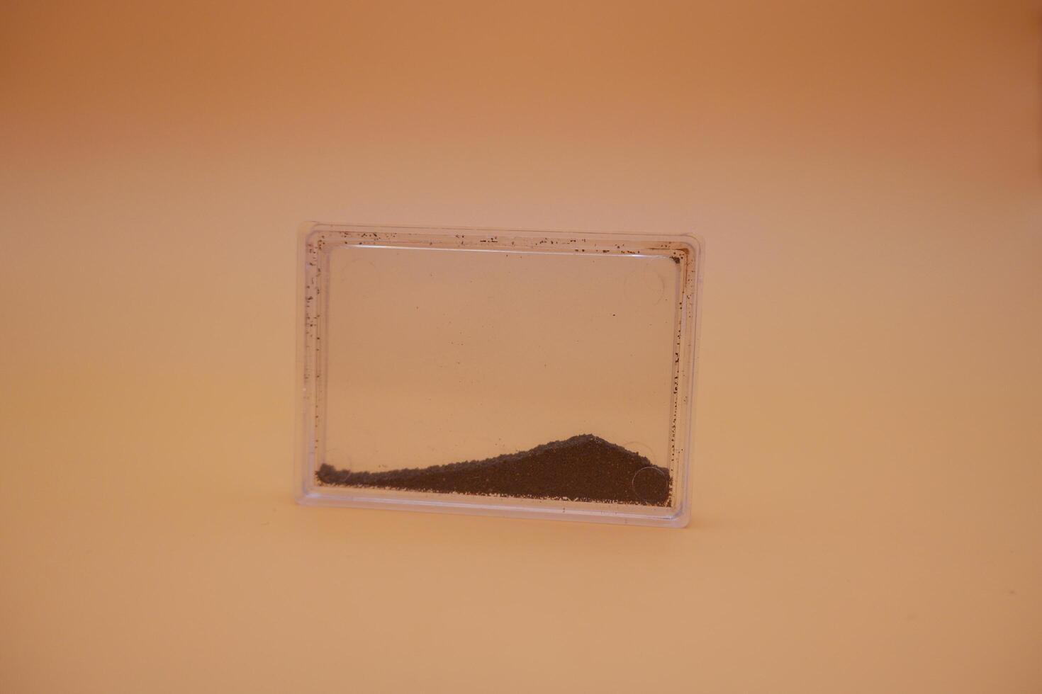 Black Iron Sand Sample in Clear Plastic Case for Mineral Collection photo