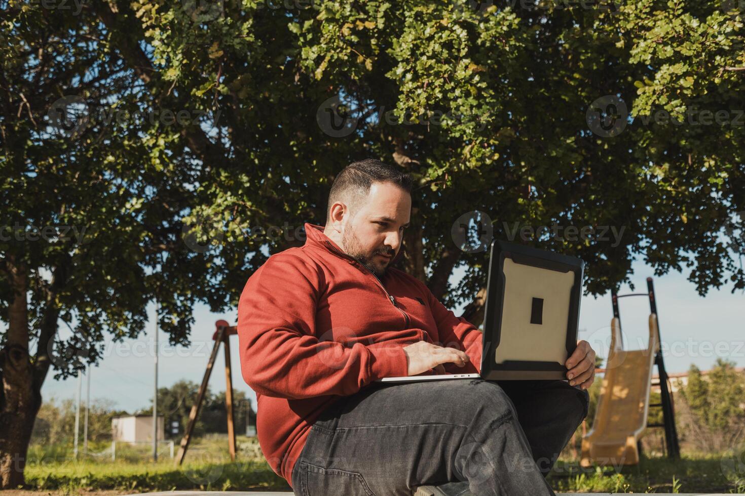 Employee On The Park Bench Focusing On The Pc Working photo