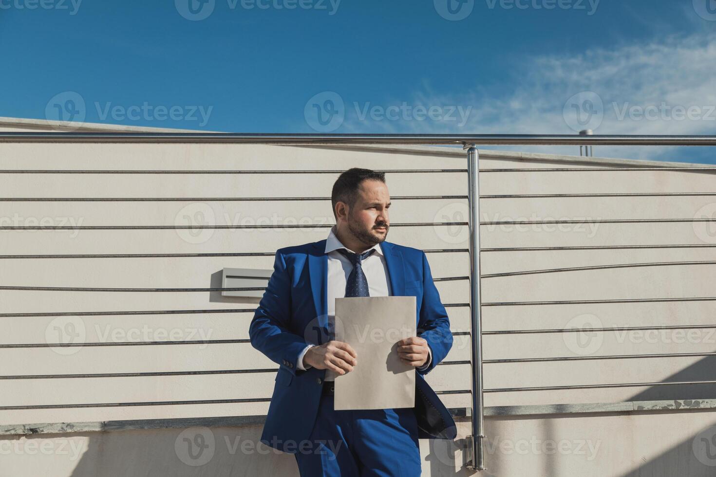 Businessman Wearing A Blue Suit Working Outdoor In The Morning photo