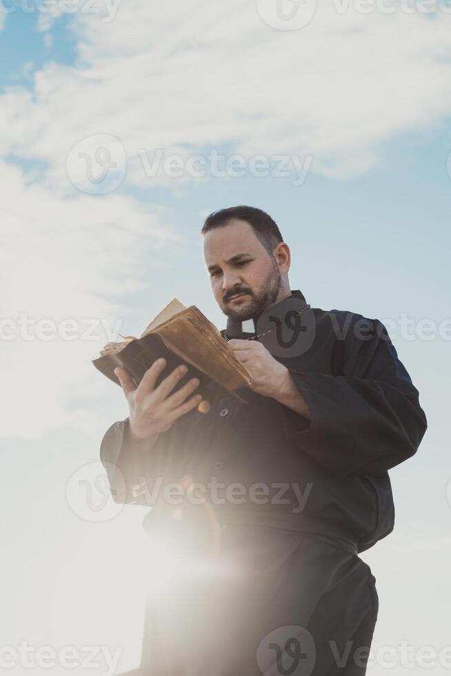 Sun Hitting The Priest Reading The Words Of God photo