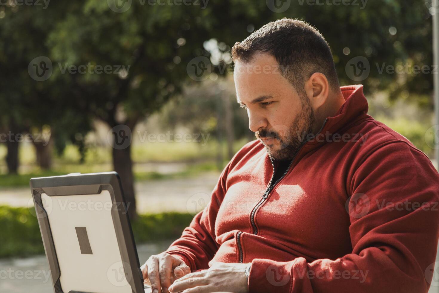 Man Working In Remote At The Park During The Day photo