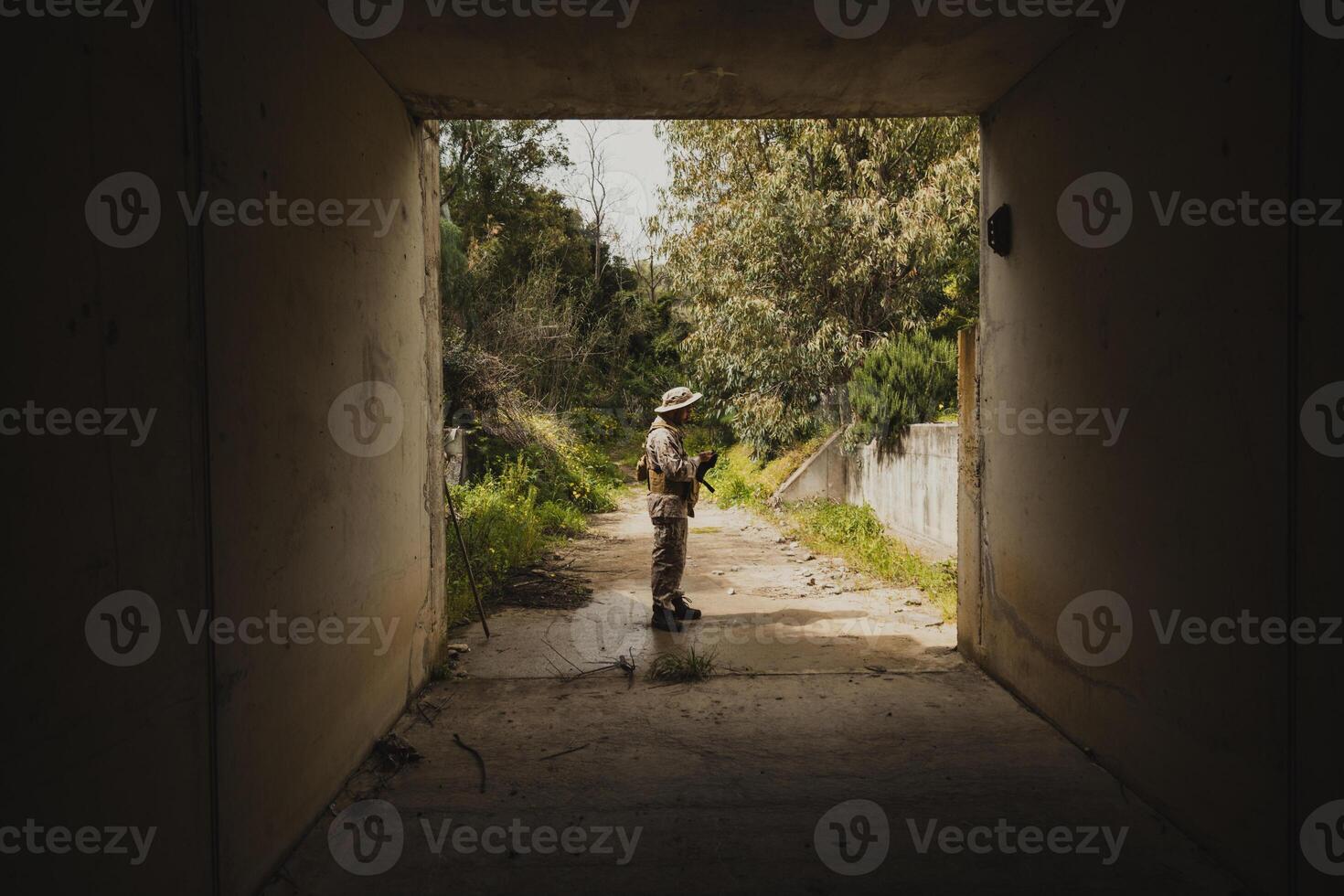 Soldier At The End Of A Dark Tunnel During War photo