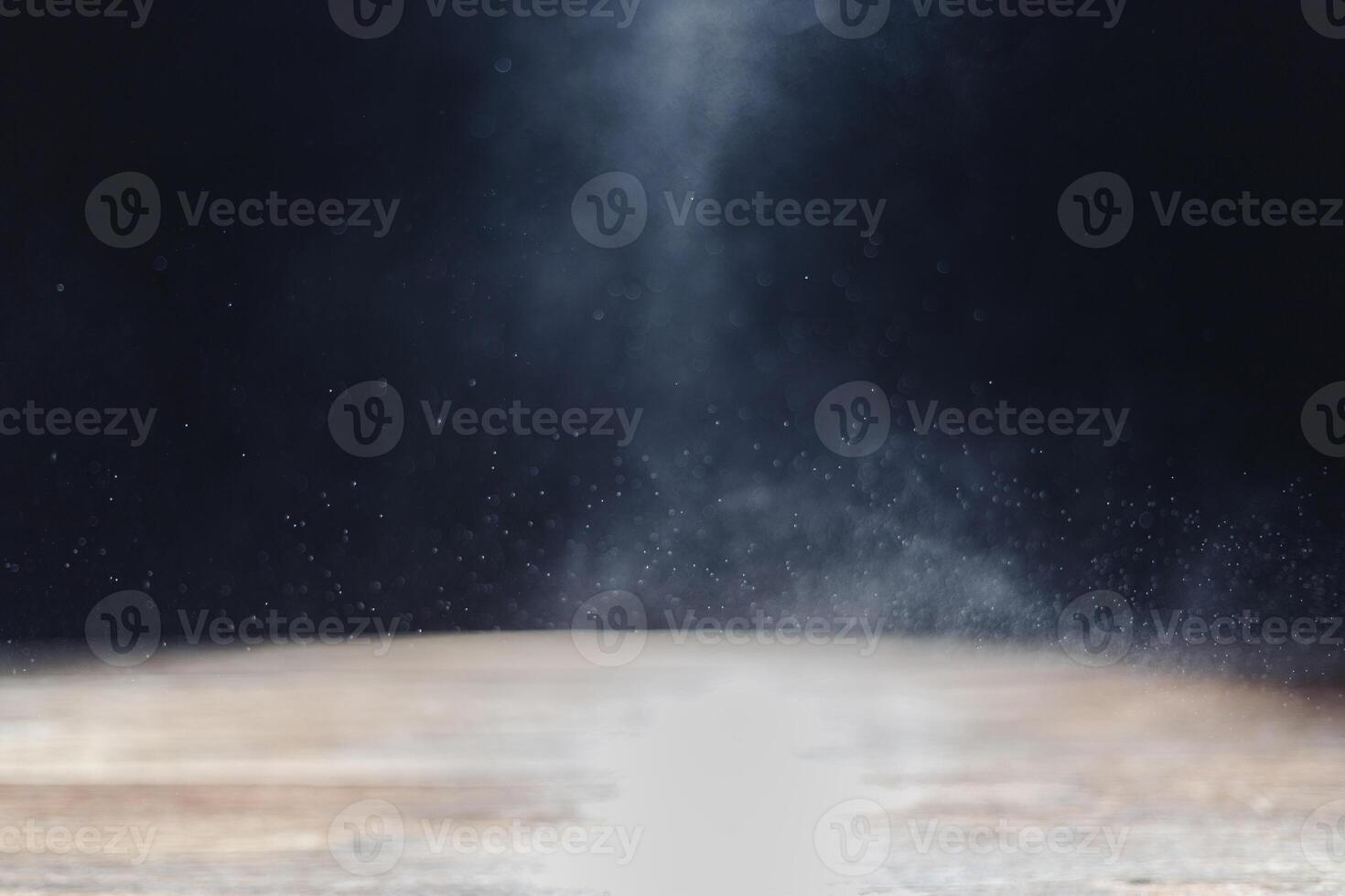 Abstract bokeh from water droplets on wooden table, dark background, shot in studio. photo