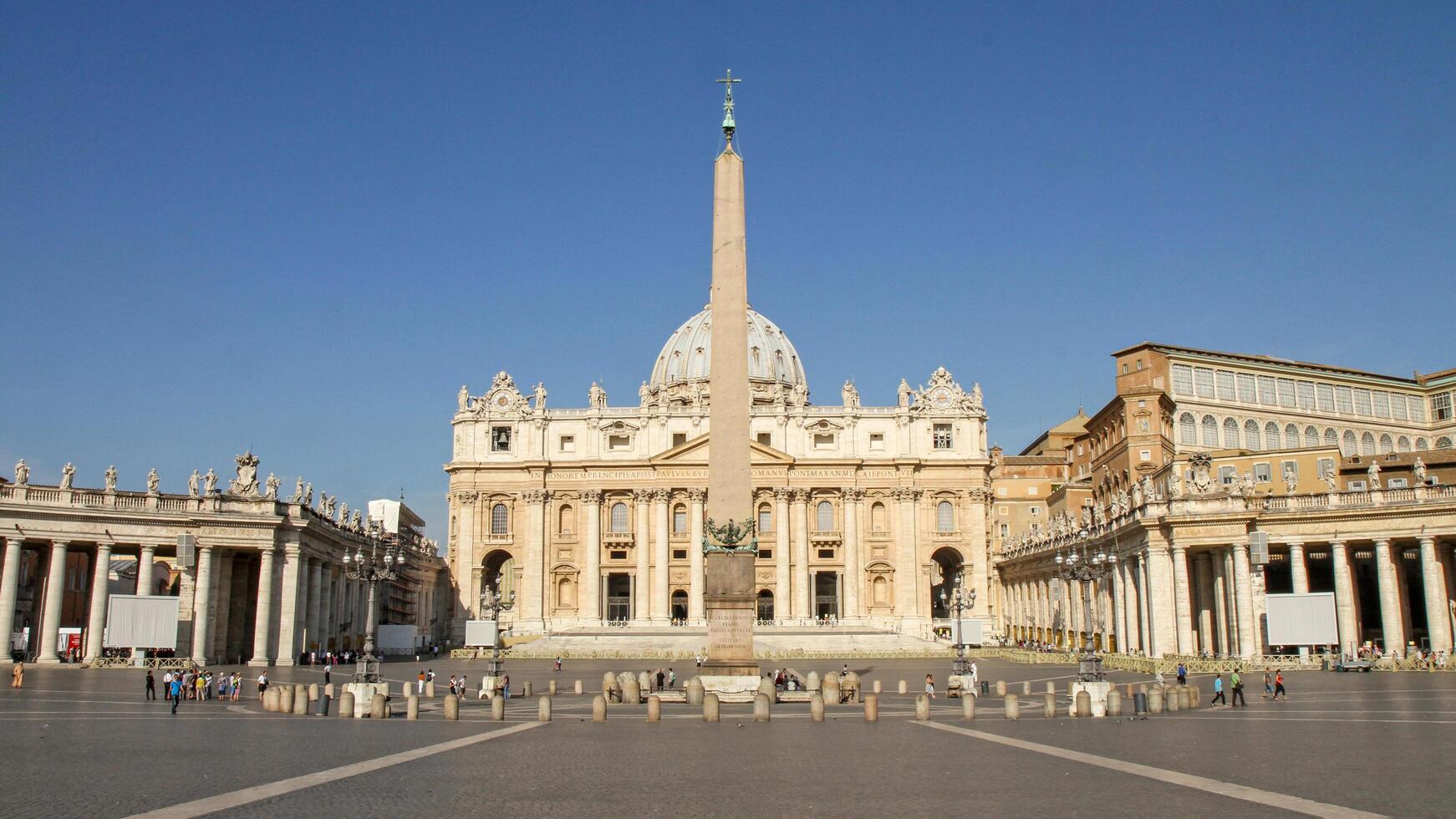 St. Peter's Basilica and the obelisk in the Vatican on a sunny day. photo