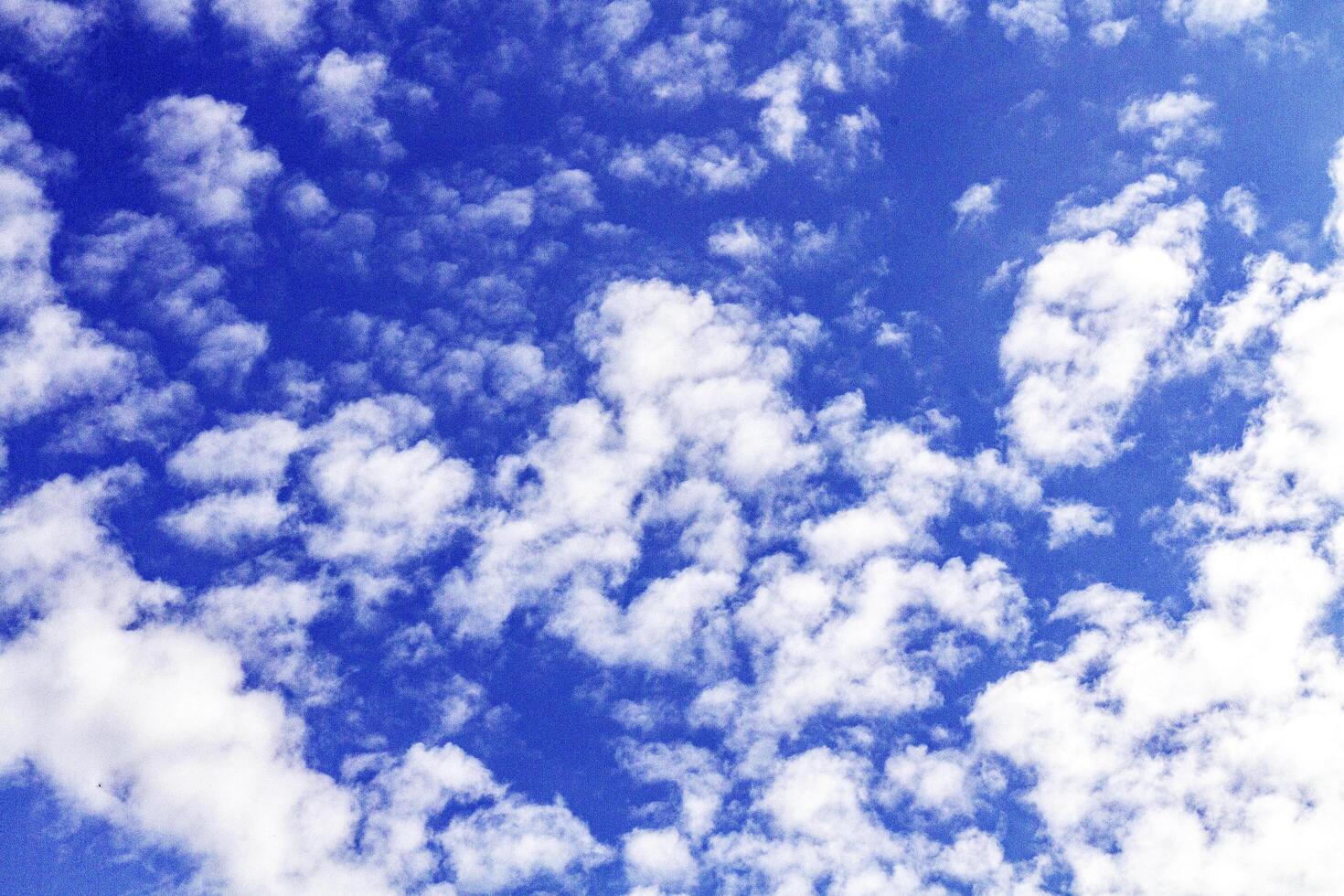Blue sky with soft white clouds on a sunny day. photo