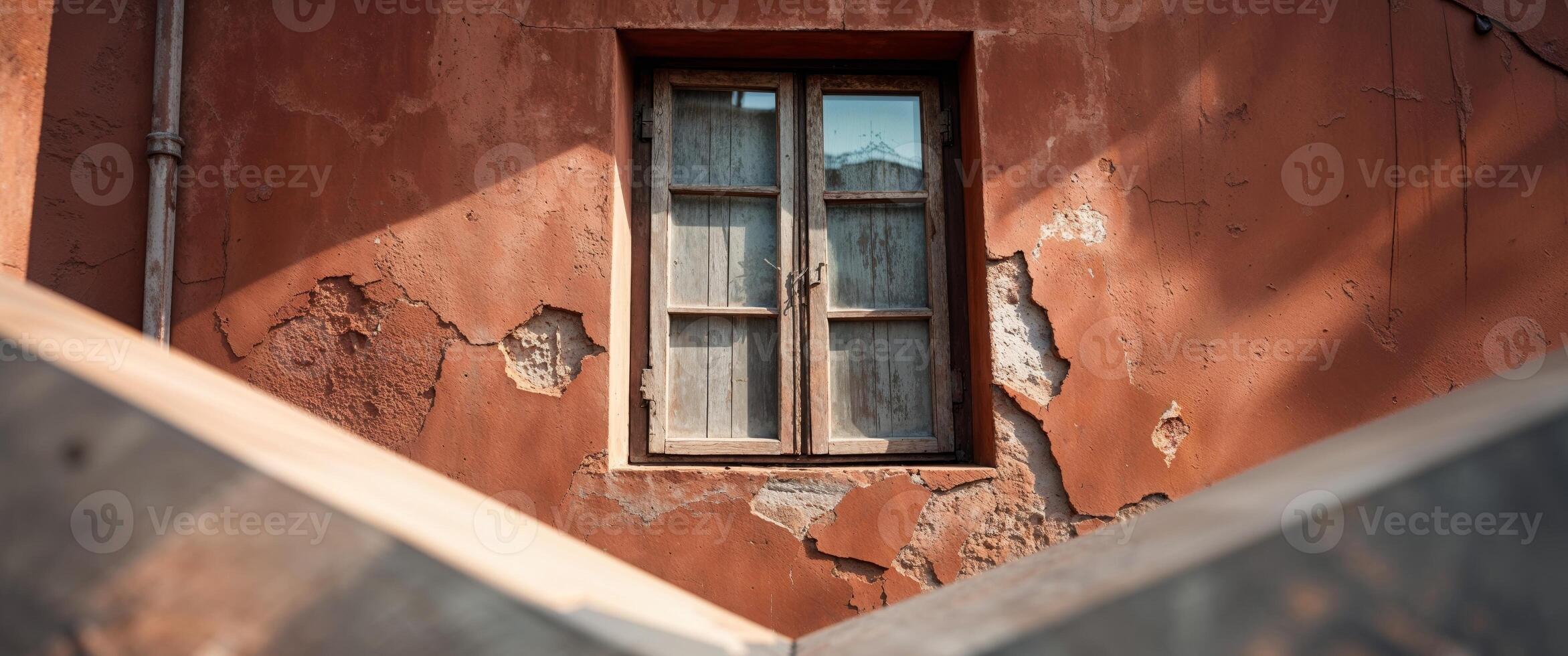 Closeup of terracotta building exterior with wooden window photo
