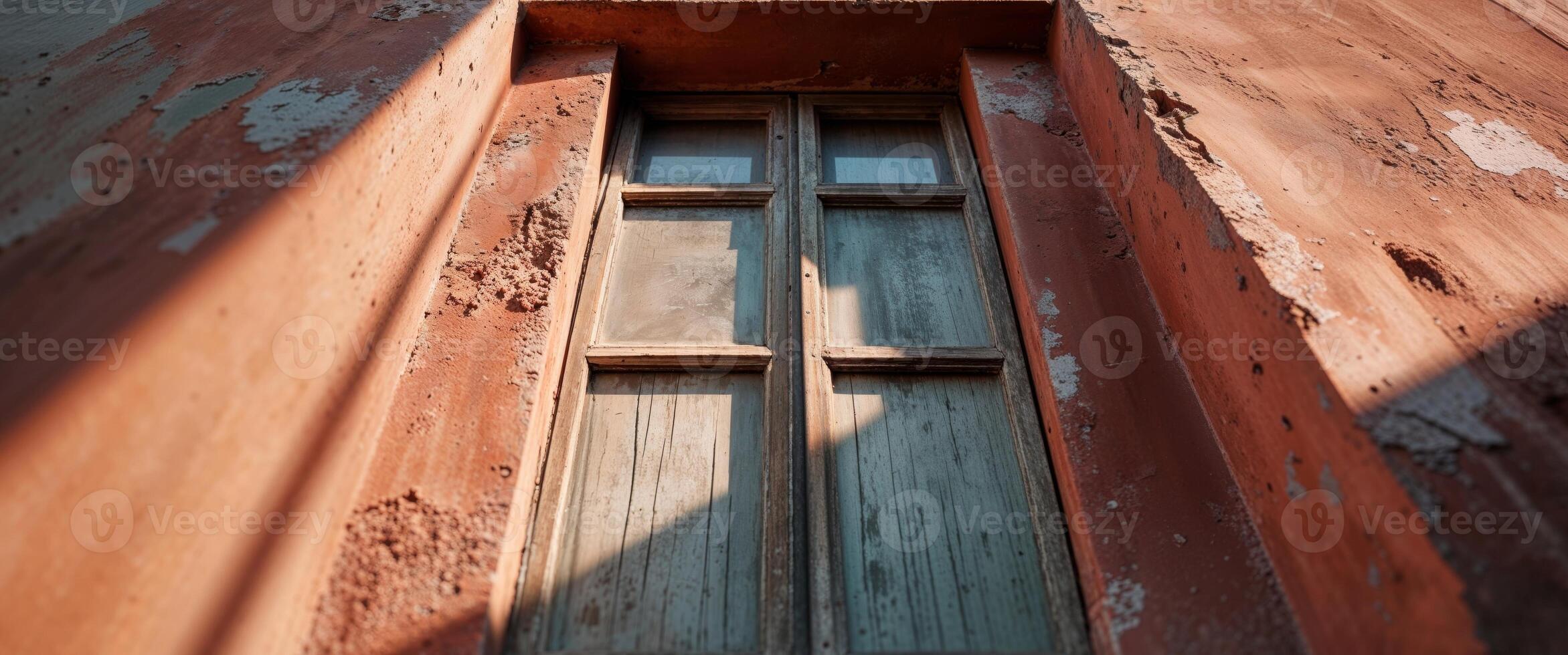A window in an old building with peeling paint photo