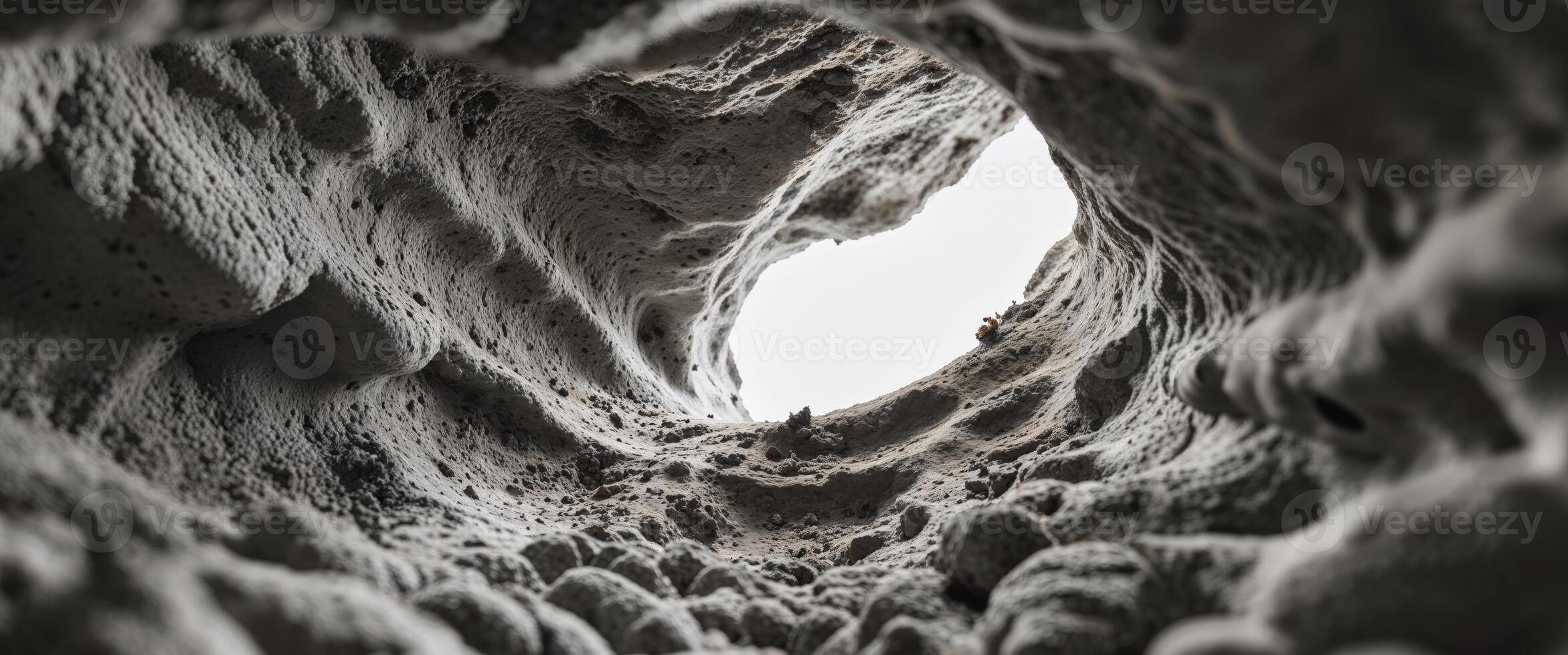 A hole in the wall of a cave with a hole in it photo