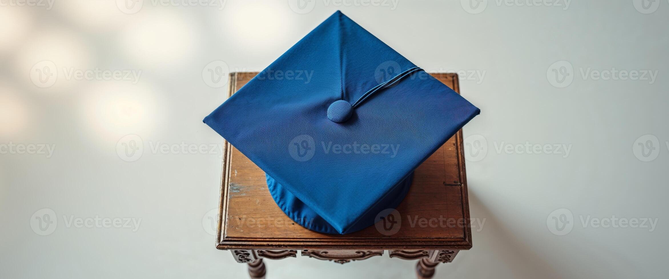 Graduation cap on miniature classroom desk photo