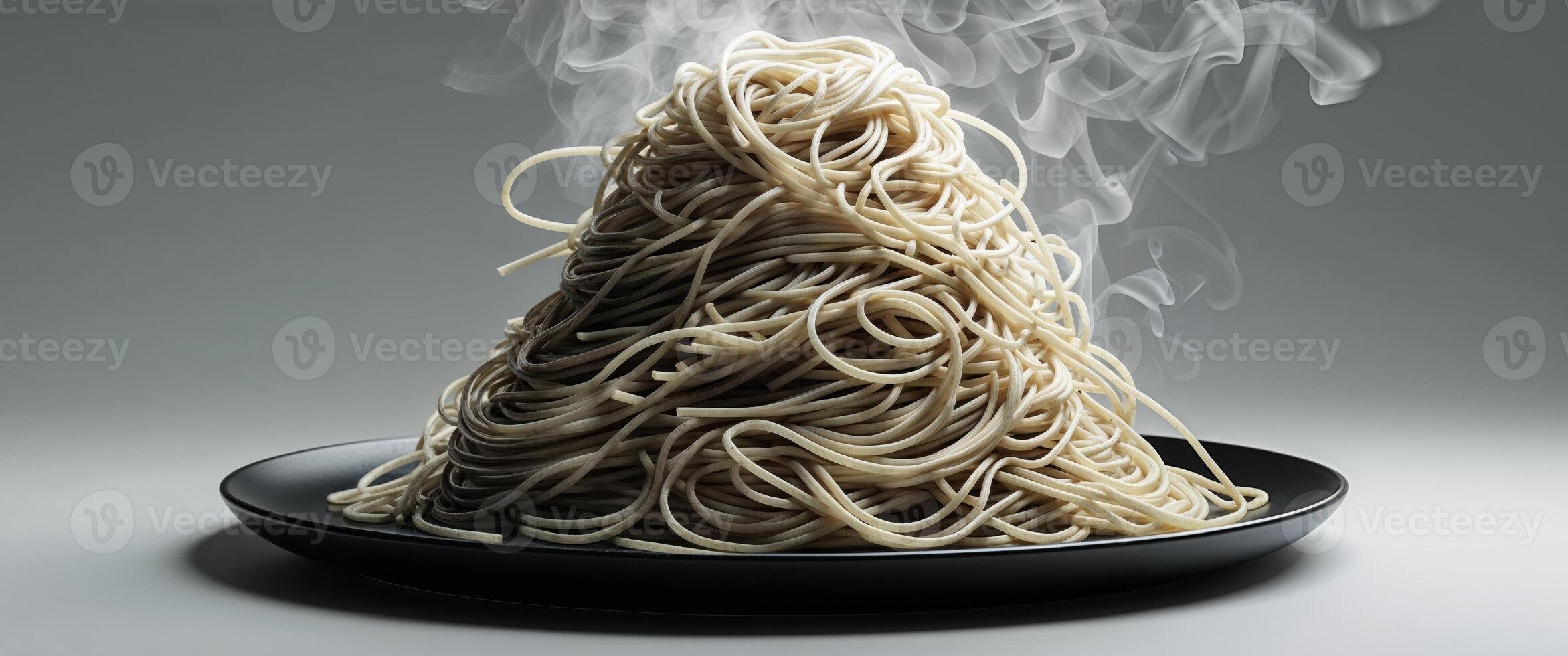 A plate of spaghetti is on top of a black plate photo