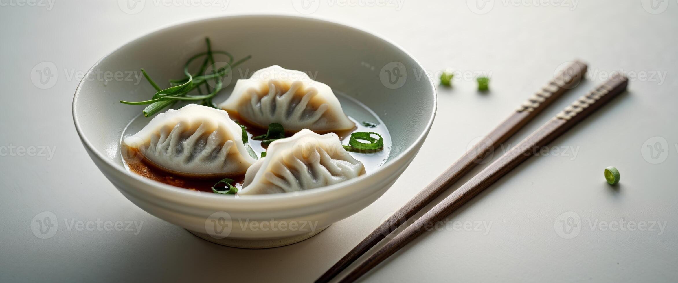 Steaming Dumplings in Bowl with Chopsticks and Dipping Sauce. photo