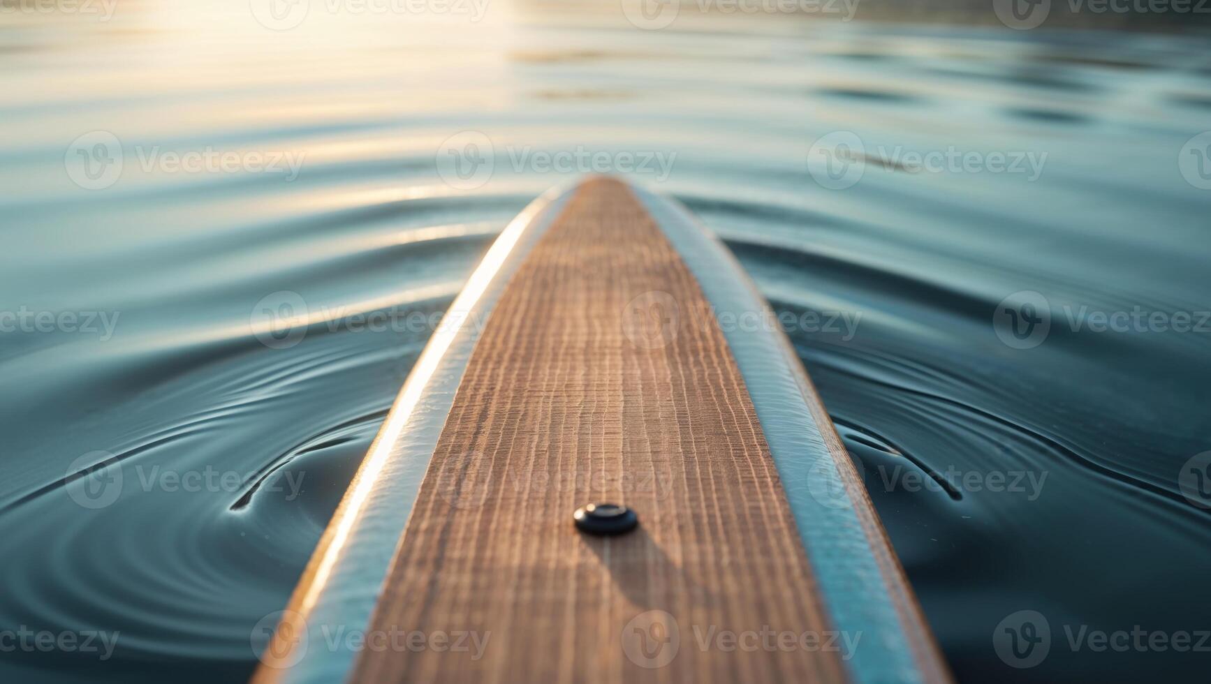 A paddleboard is in the water with a wave photo
