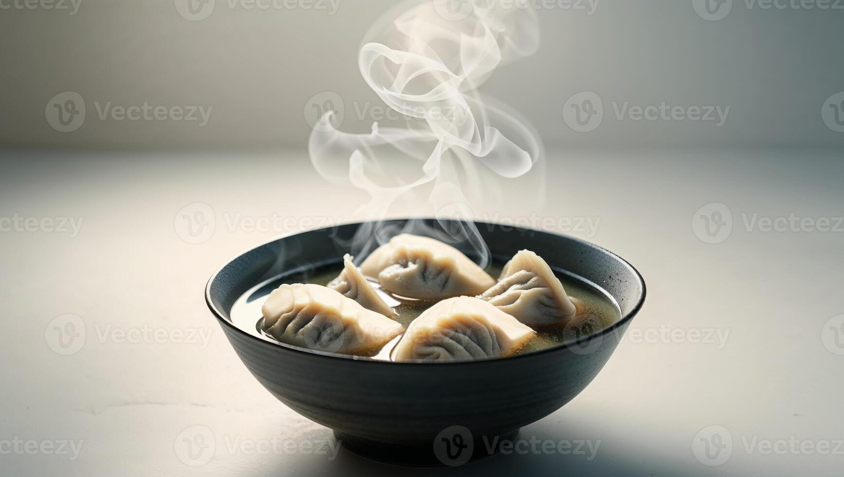 bowl of savory dumplings in clear broth comforting and delicious meal photo