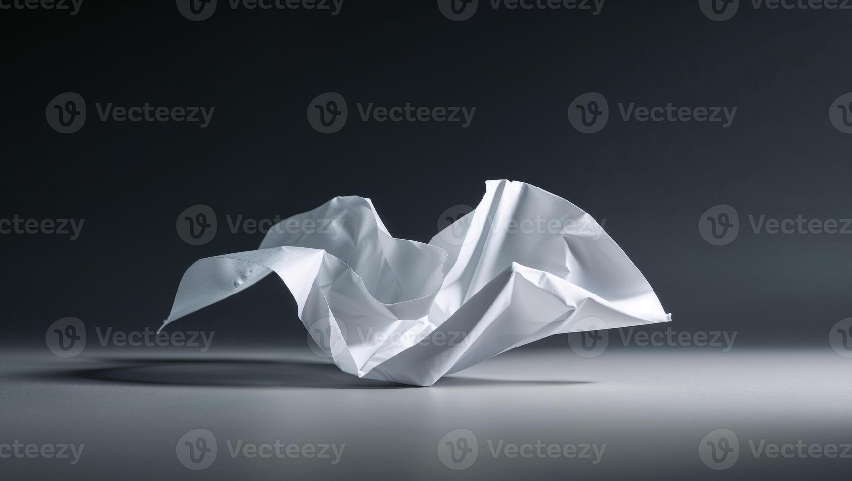 A folded white paper is shown on a table photo