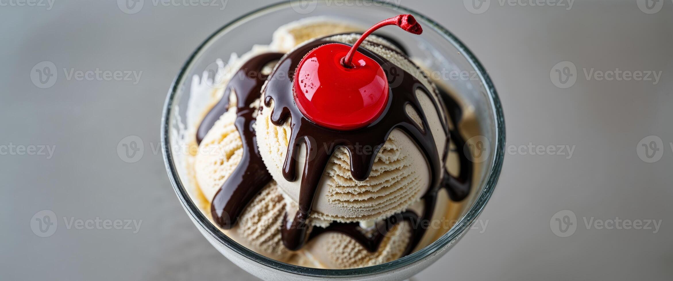 A sundae with chocolate and cherry on top photo